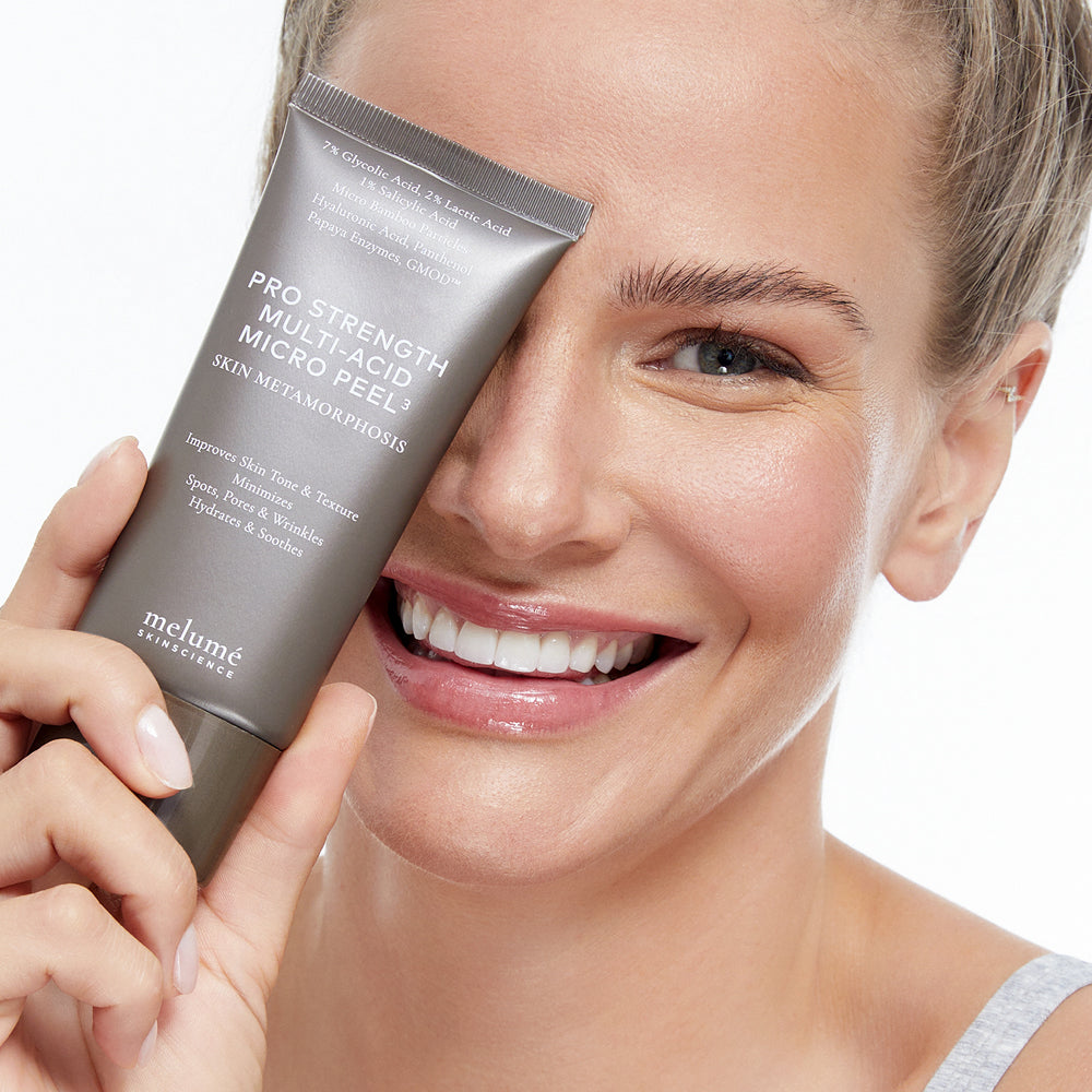 image mood of holding pro strength multi-acid micro peel in her hand while smiling