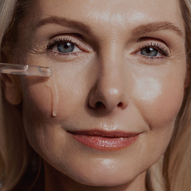 image of woman applying serum onto her face