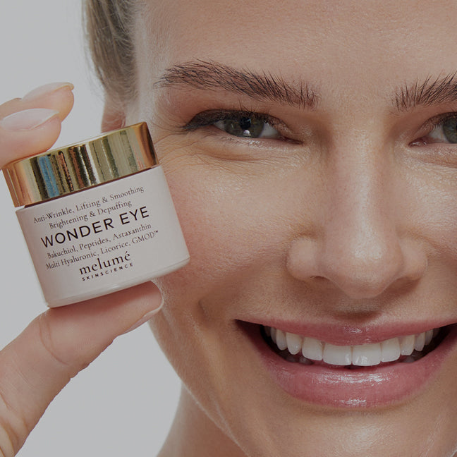 image of model holding eye cream