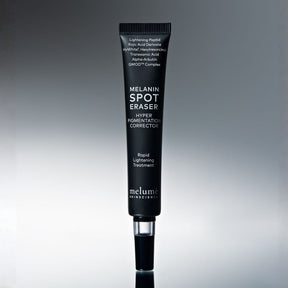 Melanin Spot Eraser tube on a gray background